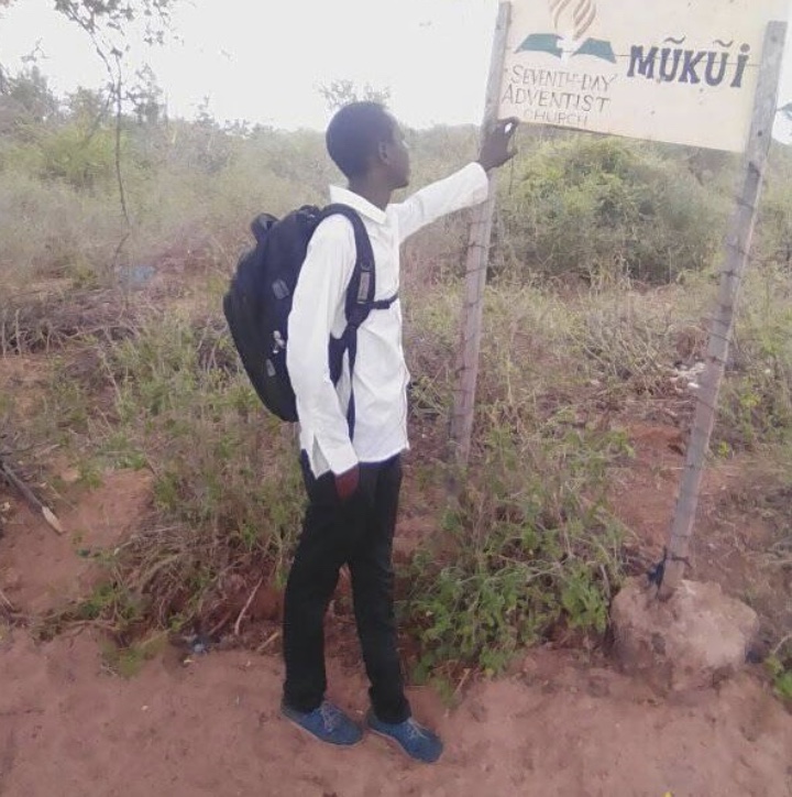 James at a Seventh-day Adventist church sign