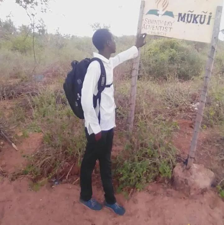 James at a Seventh-day Adventist church sign