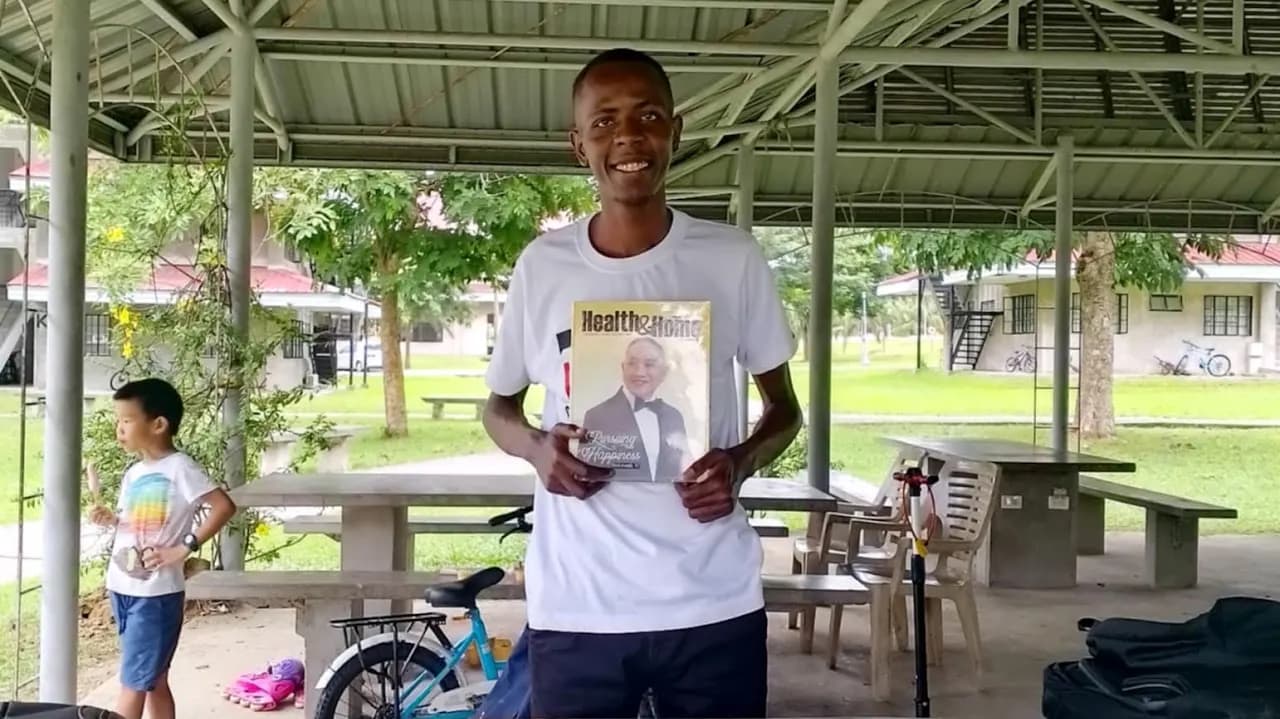 James holding a book during literature evangelism